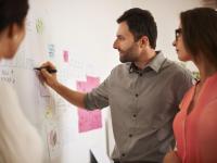 Executive writing down some data on the board