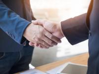 Two confident business man shaking hands during a meeting in the office, success, dealing, greeting and partner concept