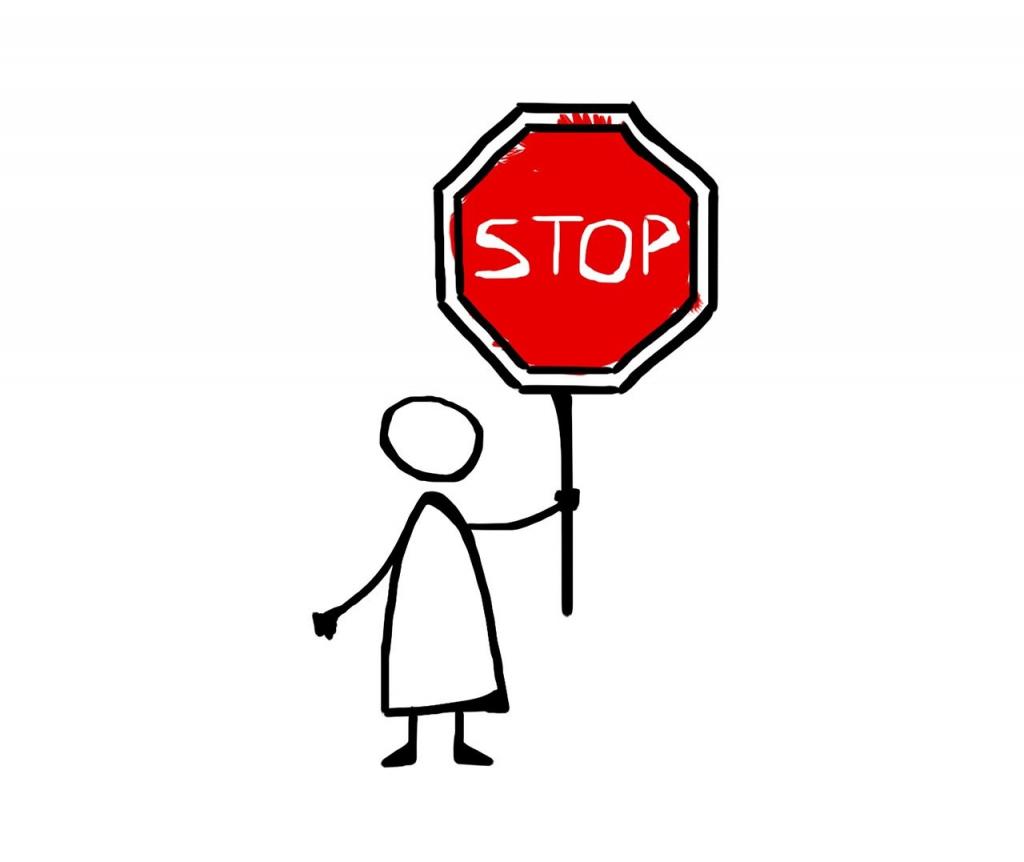 Descrição da imagem: Figura de boneco sem rosto segurando uma placa de trânsito no formato hexagonal, com contornos pretos e fundo na cor vermelho. No centro da placa consta a escrita "stop".