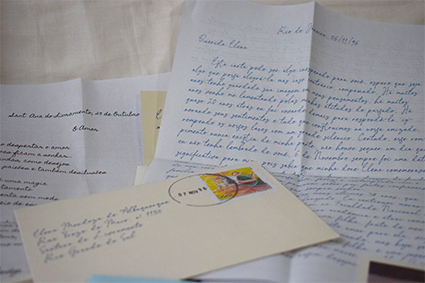 Cartas escritas a mão e envelope com carimbo e selo dos Correios